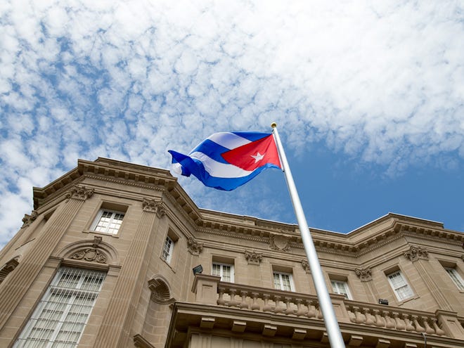 The Cuban flag is raised over their new embassy in Washington on Monday.