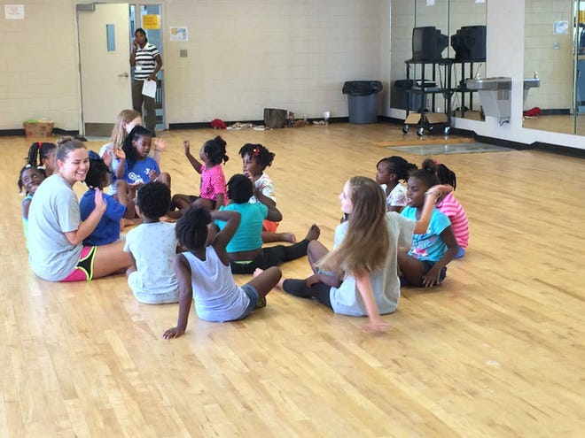 Kaitlin Bain/Savannah Morning News-On the last day of the camp, Katie Daly, Savannah Youth Dance Project gave each of the campers a certificate of completion for the class as well as a Savannah You Dance Project sticker.