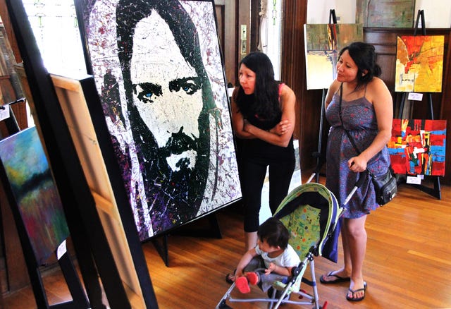 JAMIE MITCHELL • TIMES RECORD
Adriana Renteria, left, and Lizeth Garvey and Augusto Mateo Renteria view the paintings of artist David Gates on Sunday, July 19, 2015, during Michael Mansion's Third Sunday Art Show. Gates was joined by artist Jimmy Leach, Pat Riggs, Lorrie Bridges and Olen for the monthly show and reception. 
 JAMIE MITCHELL • TIMES RECORD
Local artist Pat Riggs works on a 4x6-foot canvas for a painting in her Turpentine Creek Series on Sunday, July 19, 2015, during Michael Mansion's Third Sunday Art Show. Riggs joined artist David Gates, Jimmy Leach, Lorrie Bridges and Olen for the monthly show and reception. Riggs' painting is a 3/4 size acrylic of "Crystal," a tiger at Turpentine Creek Wildlife Refuge. Located in Eureka Springs, Turpentine Creek provides refuge for rescued animals, with an emphasis on tigers, lions, leopards, and cougars. 
 JAMIE MITCHELL • TIMES RECORD
Adriana Renteria, left, and Lizeth Garvey and Augusto Mateo Renteria view the paintings of artist David Gates on Sunday, July 19, 2015, during Michael Mansion's Third Sunday Art Show. Gates was joined by artist Jimmy Leach, Pat Riggs, Lorrie Bridges and Olen for the monthly show and reception.
