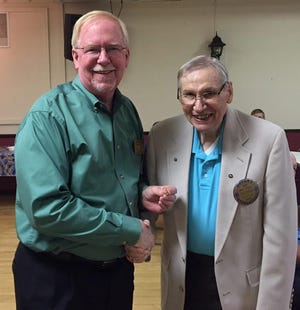 Rick Briscoe presents Bob Rumsey with a pin. Courtesy Photo