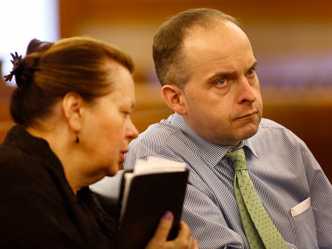 A court interpreter translates the proceedings into Polish for Radoslaw Czerkawski at his sentencing in Dedham Superior Court on larceny charges on Tuesday, July 21, 2015. He was found guilty of stealing from 95-year-old
Janini Stock of Quincy.