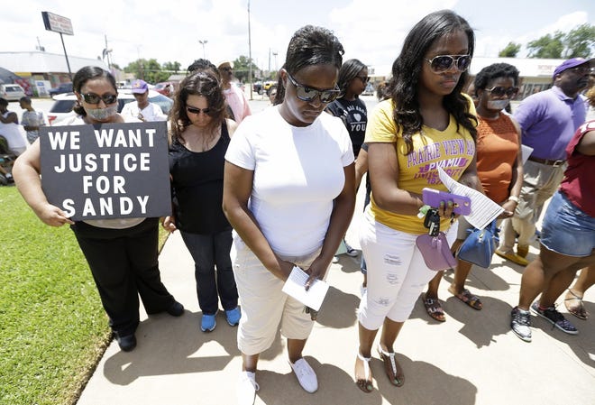 Protesters prayer at rally outside the Waller County Courthouse after a march from the Waller County Jail in Hempstead, Texas, Friday July 17, 2015, to protest the death of Sandra Bland, who was found dead in the jail. Waller County District Attorney Elton Mathis said there were no cameras in Bland's jail cell to show if the Illinois woman hanged herself in the lockup as a medical examiner has ruled. Her relatives and supporters dispute the finding.