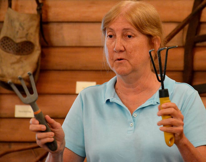 Lyn Hecker, president of the Burlington County Gardeners Association, shows some of her gardening tools Wednesday.