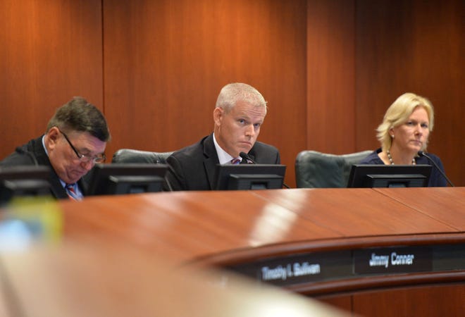 From left, Lake County Commissioners Jimmy Conner, Sean Parks and Leslie Campione listen to a speaker during a Lake County Commission meeting about the Wellness Way Sector Plan at the Lake County Administration building in Tavares on July 21.