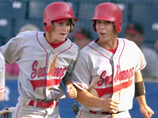 Seabreeze High's Randy Pruitt, left, and Ben Hall are all smiles after scoring on teammate Steven Will's fifth-inning triple against Cape Coral High during the FHSAA Class 4A semifinal May 16, 2001, at Legends Field in Tampa. Seabreeze won 6-4 and advanced to the championship.