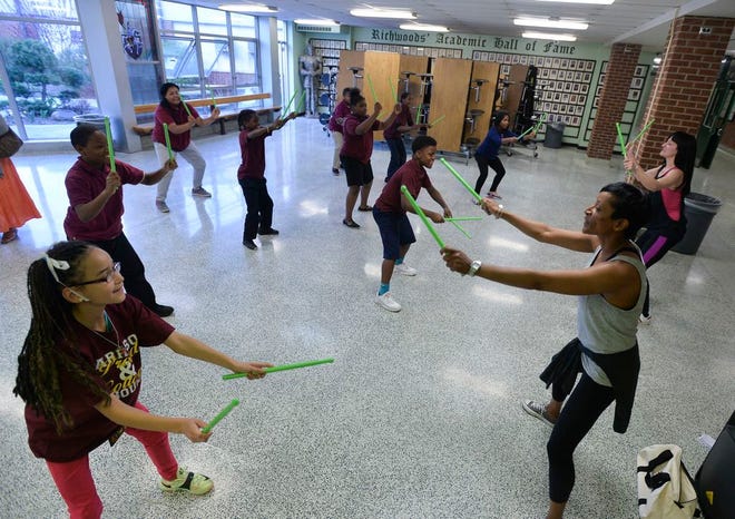 Camille Coates, right, leads a class of students in a Rockout Workout exercise class during a Parent University session on April 16, 2015 at Richwoods High School.