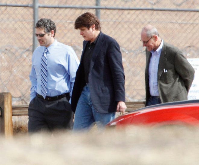 In this March 15, 2012 file photo Former Illinois Gov. Rod Blagojevich, center, walks with attorneys as he arrives at the Federal Correctional Institution Englewood in Littleton, Colo., to begin serving his 14-year sentence for corruption. The 7th U.S. Circuit Court of Appeals overturned some of the corruption convictions of the imprisoned former Governor in a ruling released Tuesday, July 21, 2015, saying prosecutors did not prove Blagojevich broke the law as he appeared to try to auction off an appointment to President Barack Obama's old Senate seat. (AP Photo/Ed Andrieski,File)