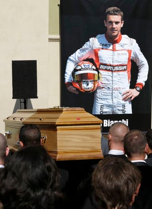 Pallbearers carry the casket of French Formula One driver Jules Bianchi into the Sainte Reparate Cathedral during his funeral in Nice, French Riviera, Tuesday, July 21, 2015. Bianchi, 25, died Friday from head injuries sustained in a crash at last year's Japanese Grand Prix. He had been in a coma since the Oct. 5 accident, in which he collided at high speed with a mobile crane which was being used to pick up another crashed car. (AP Photo/Lionel Cironneau)