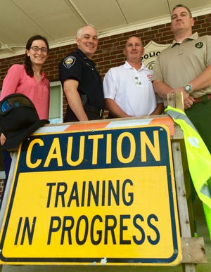 Emily Martuscello of N.H. Homeland Security, Police Chief Stephen DuBois, Deputy Fire Chief Jim Heinz and police Lt. Chris Cummings prepare for mass casualty training on Friday at Portsmouth's middle and senior high schools. Photo by Elizabeth Dinan/seacoastonline.com