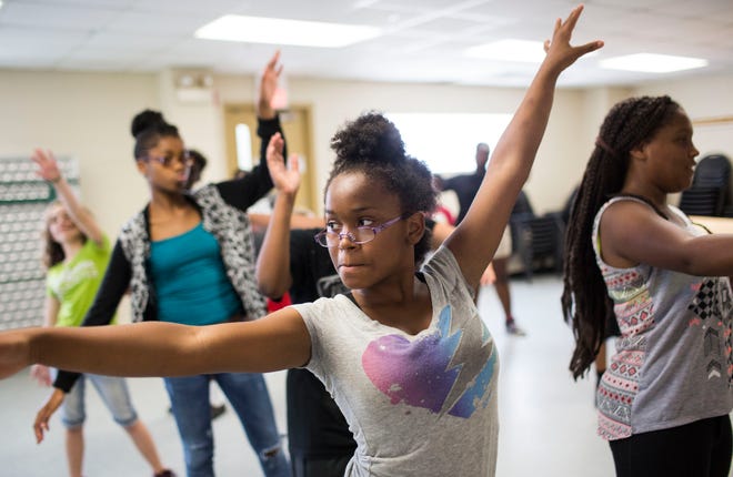 Alisha Turner dances with Fuzion DanceÕs Mary Allison during a summer pilot project by the Florida Association of Teaching Artists during the Newtown Estates Camp on July 6, 2015.  STAFF PHOTO / NICK ADAMS