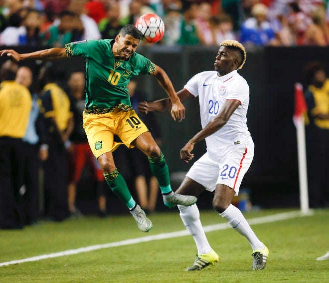 Jamaicaís Joel McAnuff heads the ball in front of the United States' Gyasi Zardes during the first half of Wednesday's CONCACAF Gold Cup soccer semifinal in Atlanta. The Associated Press