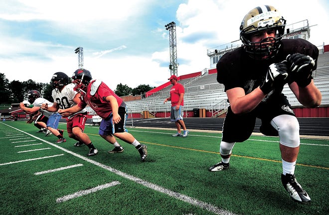 Tuscarawas Central Catholic's Zach Broadbent (right) works through drills with the East All-Star offensive line during Wednesday's practice at Quaker Stadium in New Philadelphia. The 38th annual Times-Reporter Charity All-Star Game is Friday in Dover.