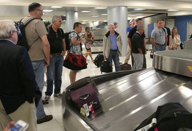 Passengers wait for their bags at Northwest Florida Beaches International Airport on Friday, May 22, 2015, in Panama City Beach, Fla. (Heather Leiphart | The News Herald)