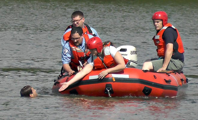 Emergency medical and rescue personnel try to talk a Yardley man into ending his hour long swim in Lake Luxembourg at Core Creek Park in Middletown Saturday, June 6, 2015. The man walked out of St. Mary Medical Center's emergency room and jumped into the Lake.