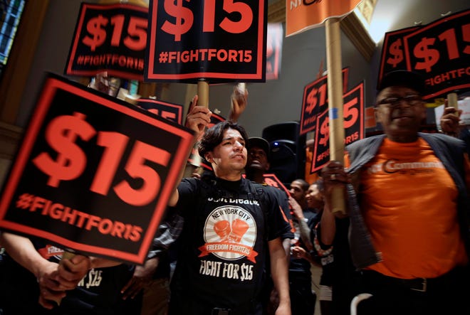 Demonstrators rally for a $15 minimum wage before a meeting of the state Wage Board in New York, which has since awarded it. (AP Photo/Seth Wenig, File)