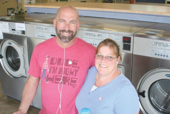 RC4SQ Passtor Scott Siddle and his wife Deena posed for a picture at the iWash laundry mat where they hosted their first Laundry Love event on Wednesday.