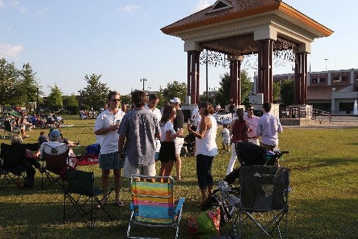 People of all ages talk in groups on the lawn at the Government Plaza during the "Live at the Plaza" concert series featuring the Lamont Landers Band in downtown Tuscaloosa, Ala. on Friday June 5, 2015. staff photo | Erin Nelson