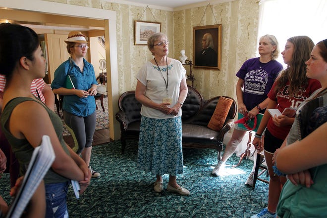 Girl Scouts from across the country tour Louisa May Alcott's Orchard House Monday morning, July 20, 2015. Tour guide Anne Cussen talks to them in the parlor. Wicked Local Staff Photo/Ann Ringwood