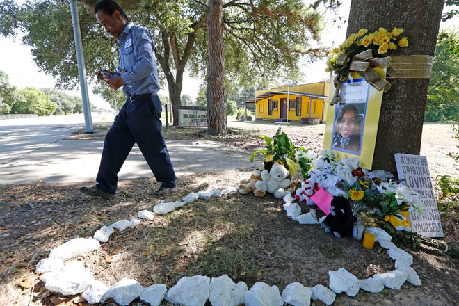 Frank Scott turns to leave after visiting a memorial to Sandra Bland on Thursday, July 23, 2015, in Prairie View, Texas, where he watered a plant he had left. "She was me," Scott said. "We both moved from the crime of the big city to live in peace" in a small town, he said. The autopsy of Bland, a black woman who was found dead in a Texas jail, revealed no injuries that would suggest she was killed by someone else, authorities said Thursday.