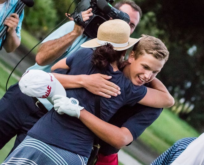 Andrew Orischak is hugged by his mother following his semifinal win on Friday.-Scott Schroeder/For Bluffton Today