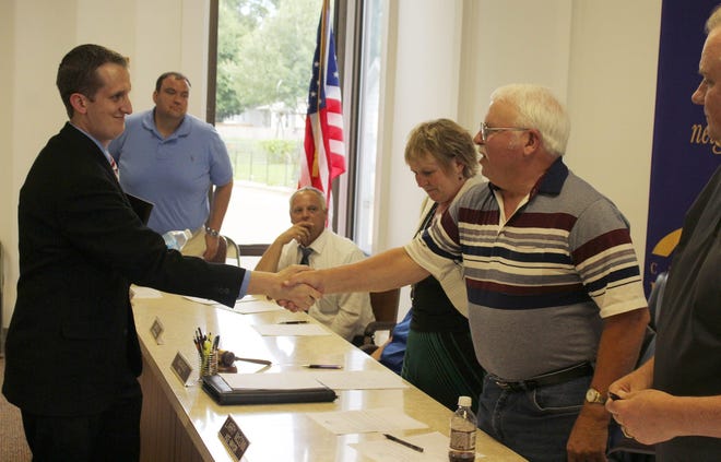 Brandon Mersman shakes the hand of vice-mayor Larry McConn after Wednesday night's interview. Mersman is set to become Bronson's next city manager. Spencer Lahr Photo