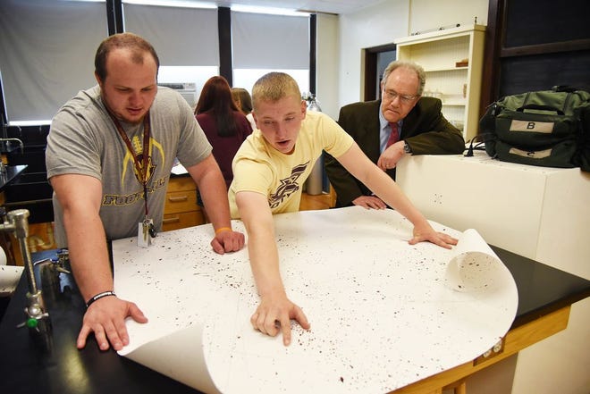 Chris Koll, a freshman from Elmwood studying criminal justice and sociology at Eureka College, explains his blood spatter analysis project to Austin Blair, a senior from Newton studying communications. The classroom was converted from a science lab to a forensic lab with the addition of Sanders Hall this year.