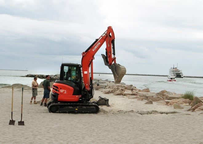 Heavy equipment is used today at Salty Brine Beach to dig up and remove an old cable. THE PROVIDENCE JOURNAL/BOB BREIDENBACH
