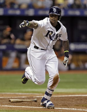 Tampa Bay Rays' Tim Beckham points into the dugout as he runs to first base after hitting a two-run single off Baltimore Orioles relief pitcher Darren O'Day during the eighth inning of a baseball game Friday, July 24, 2015, in St. Petersburg, Fla. Rays' John Jaso and Evan Longoria scored on the play.