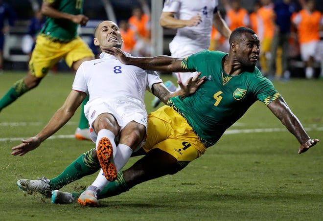 United States' Clint Dempsey, left, collides with Jamaica's Wes Morgan during the second half of Wednesday's CONCACAF Gold Cup soccer semifinal in Atlanta. Jamaica won 2-1. The Associated Press