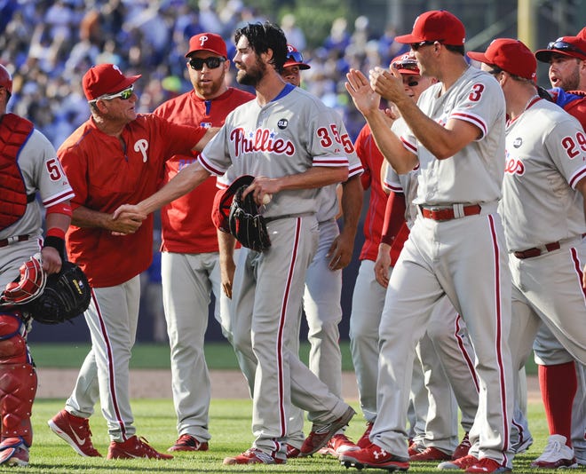 Philadelphia Phillies starting pitcher Cole Hamels, center, is congratulated by teammates after he pitched a no-hitter against the Chicago Cubs, during a baseball game in Chicago on Saturday, July 25, 2015. The Phiillies won 5-0. (AP Photo/Matt Marton)