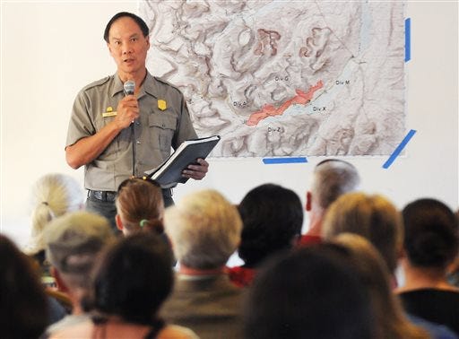 Glacier National Park Superintendent Jeff Mow speaks to the crowd during a public information meeting regarding the wildfires in the national park Friday, July 24, 2015, in St. Mary, Mont. Glacier officials emphasized that only a small part of the 1,718-square-mile park is closed as the flames chew though parched conifer-topped ridges on its eastern side. (Aaric Bryan/The Daily Inter Lake via AP)