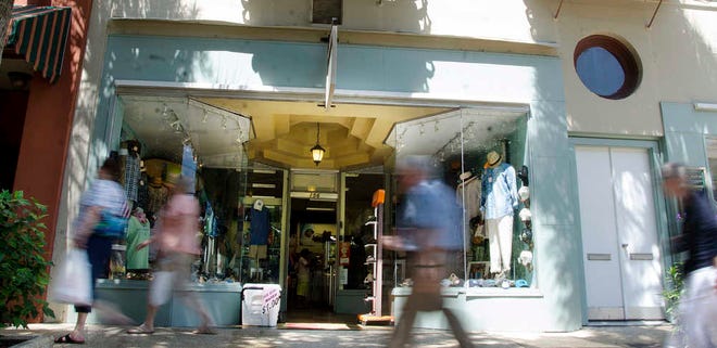 PETER.WILLOTT@STAUGUSTINE.COMPedestrians walk past the H.W. Davis Clothing and Shoes store on St. George Street in St. Augustine on Friday, July 24, 2015. The owners of the business expect the city's upcoming 450th birthday celebrations to be good for their business by attracting people to downtown St. Augustine.