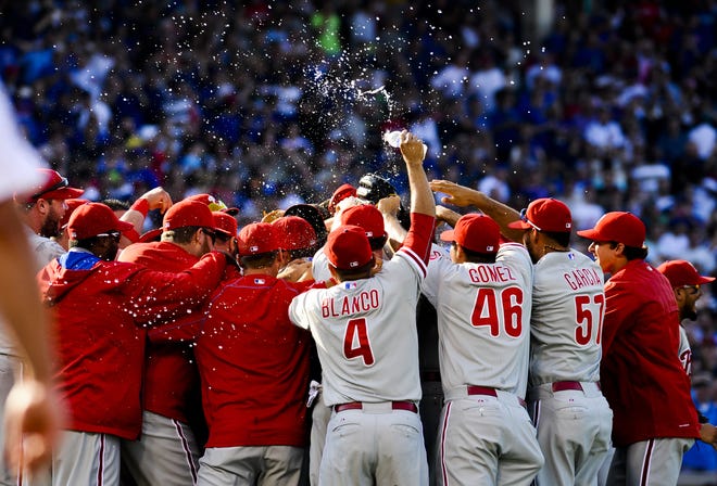 Philadelphia Phillies starting pitcher Cole Hamels gets hugged by teammates after he threw a no-hitter against the Chicago Cubs in a baseball gamein Chicago on Saturday, July 25, 2015. The Phillies won 5-0. (AP Photo/Matt Marton)