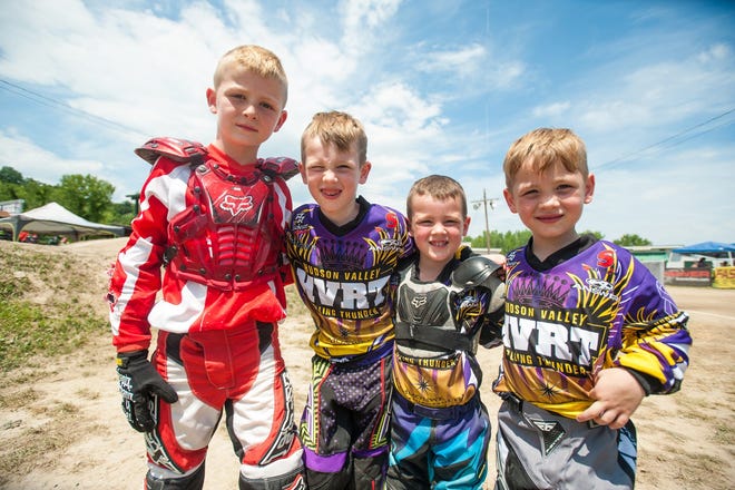From left, Keegan Oxford stands with his cousins Landen, Owen and Gage during the Empire State Nationals at Kingston Point BMX in Kingston on Saturday. Kelly Marsh/For the Times Herald-Record