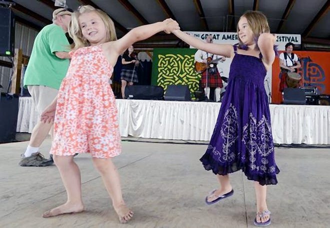 From left, Sophia Sousouris and Emily Gustin, 7, dance with each other during the Great American Irish Festival at the Herkimer County Fairgrounds on Saturday. GATEHOUSE NEW YORK PHOTO/TINA RUSSELL
