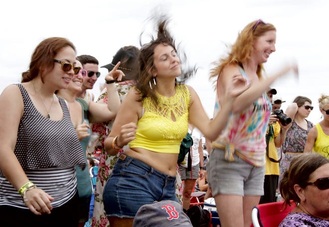 From left, Erin Gomes, of New Jersey; Rachel Abrams, of Boston; Melanie Silvermail, of New York City; and Erin Briskie, of Philadephia, dance to the music of Lord Huron Sunday afternoon. The Providence Journal / Kris Craig