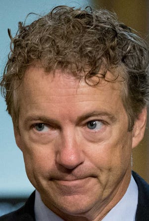 Republican presidential candidate Sen. Rand Paul, R-K.Y., arrives before Secretary of State John Kerry, Secretary of Energy Ernest Moniz, and Secretary of Treasury Jack Lew, arrive to testify at a Senate Foreign Relations Committee hearing on Capitol Hill, in Washington, Thursday, July 23, 2015, to review the Iran nuclear agreement. (AP Photo/Andrew Harnik)