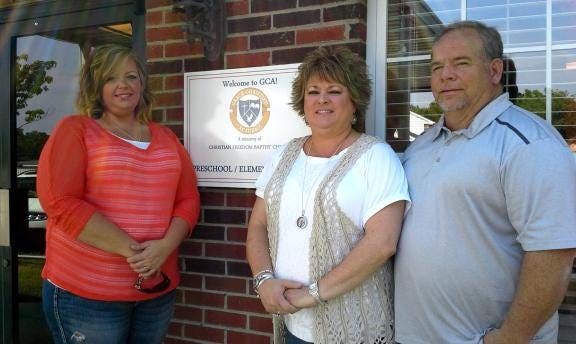 Melissa Atkinson, left, received an Opportunity Scholarship for her daughter to attend Grace Christian Academy in Kings Mountain. Administrative Director Stephanie Chambers, center, and Headmaster Mike Chambers, say eight students at the school will receive the scholarships.
