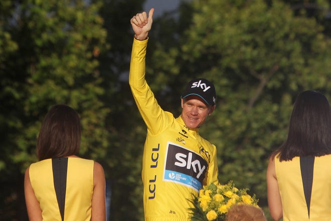 Tour de France winner Chris Froome of Britain celebrates on the podium after the twenty-first and last stage of the Tour de France cycling race over 109.5 kilometers (68 miles) with start in Sevres and finish in Paris, France, Sunday, July 26, 2015.