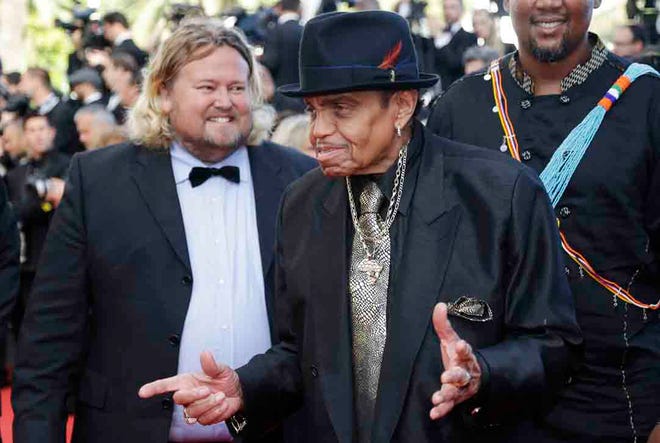 In this Friday, May 23, 2014 file photo, Joe Jackson arrives for the screening of Sils Maria at the 67th international film festival, Cannes, southern France. A Brazilian hospital says Joe Jackson - the father of the late Michael Jackson and the patriarch of the musical family - suffered a stroke while visiting the South American nation. An emailed statement early Monday, July 27, 2015 from the Albert Einstein hospital in Sao Paulo says only that Jackson was admitted to the hospital Sunday afternoon. He is in the intensive care unit. (AP Photo/Thibault Camus, file)