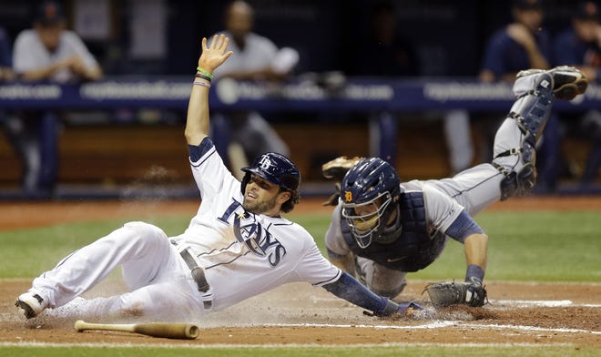 Tampa Bay Rays' David DeJesus, left, slides around the tag from Detroit Tigers catcher Alex Avila while scoring on an RBI single by Logan Forsythe during the fifth inning of a baseball game Monday, July 27, 2015, in St. Petersburg, Fla. (AP Photo/Chris O'Meara)