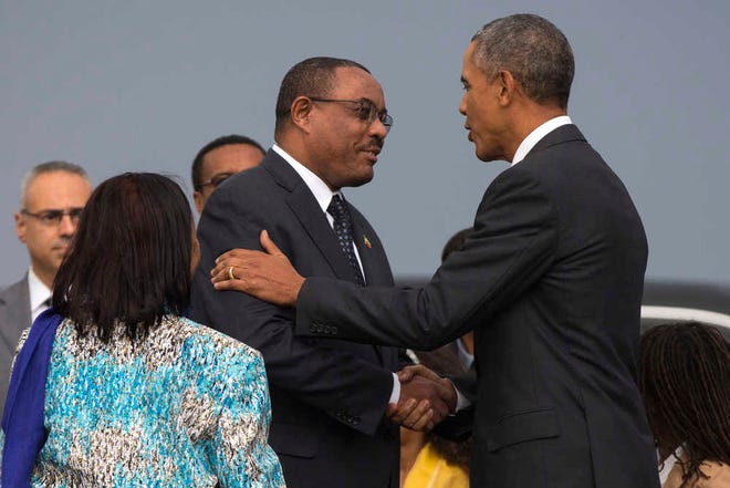 President Barack Obama, right, shakes hands with Ethiopian Prime Minister Hailemariam Desalegna after arriving at Addis Ababa Bole International Airport, on Sunday, July 26, 2015, in Addis Ababa. Obama is the first sitting U.S. president to visit Ethiopia. (AP Photo/Evan Vucci)