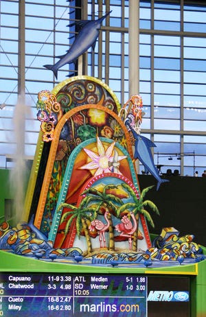 The home run sculpture at Marlins Park lights up after Justin Ruggiano hit a solo home run in a baseball game against the Washington Nationals in 2012 in Miami. The colorful home run sculpture in Marlins Park doesn't get much use because the stadium is the toughest in the majors to hit a homer. (AP Photo/Wilfredo Lee)