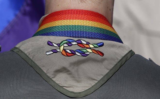 In this Sunday, June 8, 2014, file photo, a Boy Scout wears his kerchief embroidered with a rainbow knot during Salt Lake City's annual gay pride parade. The Boy Scouts of America's top policy-making board planned a vote Monday, July 27, 2015, on ending its blanket ban on gay adult leaders while allowing church-sponsored Scout units to maintain the exclusion if that accorded with their faith. (AP Photo/Rick Bowmer, File)