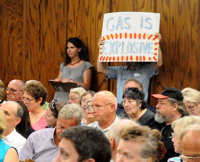(File) Bill Reitter, of Gloucester County, held a sign opposing the pipeline being built at the the Manchester Township Municipal Building Tuesday afternoon, July 28, 2015, during a New Jersey Board of Public Utilities public hearing on proposed natural gas pipeline through northern Burlington County and other parts of New Jersey.
