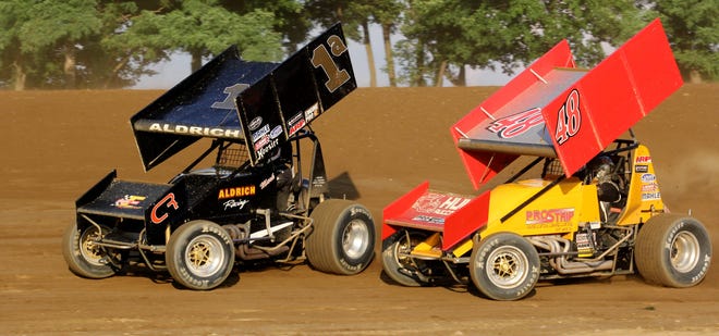 Kevin Atkins (48) battles with Mark Aldrich during the first SOD A-Main of the night Saturday. ANDY BARRAND PHOTO