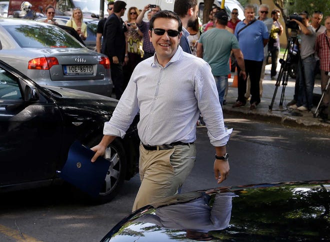 Thanassis Stavrakis/The Associated PressGreece's Prime Minister Alexis Tsipras arrives at Syriza party headquarters on Monday for a meeting with senior party officials in Athens.