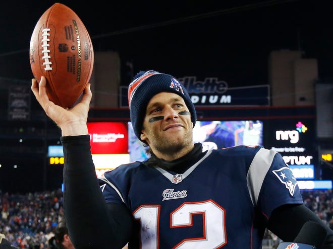 In this Jan. 10, 2015, file photo,ÊNew England Patriots quarterback Tom Brady holds up the game ball after an NFL divisional playoff football game against the Baltimore Ravens in Foxborough, Mass.