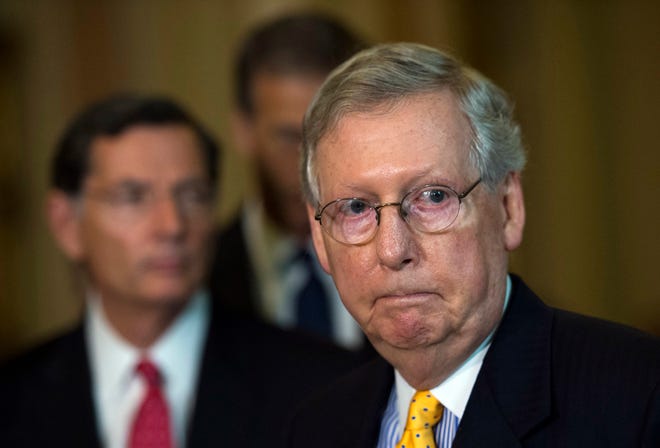 Senate Majority Leader Mitch McConnell, R-Ky., listens to remarks while addressing the media after a policy luncheon on Capitol Hill in Washington, Tuesday, July 21, 2015. Republican and Democratic negotiators in the Senate announced an agreement on a six-year highway and transit bill, subject to approval by rank-and-file lawmakers. (AP Photo/Molly Riley)