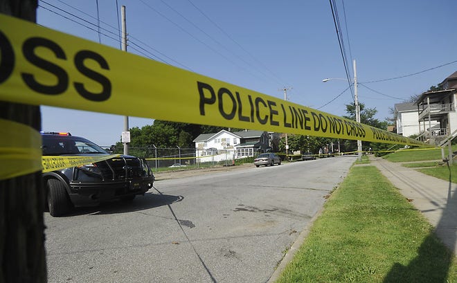 Police tape is wrapped around the scene of a fatal shooting in the 200 block of East Eighth Street in Erie on July 11. An Erie police vehicle stands by, left. Fourteen-year-old Derrys Sanders, Jr. is accused of fatally shooting East High School student Jacob Pushinsky, 18, while Pushinsky was riding his bike. GREG WOHLFORD/
